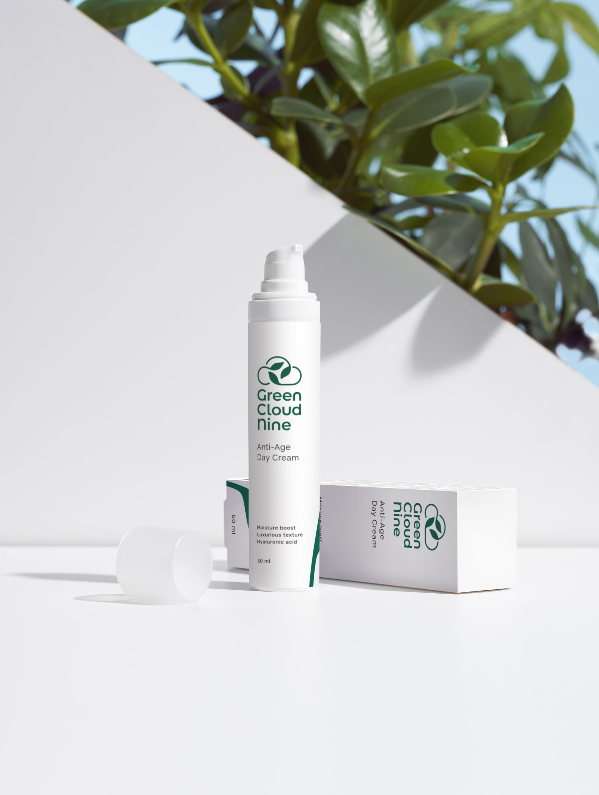 Anti-Age Day Cream with box. White pump with green cloud nine logo on a white background with plants