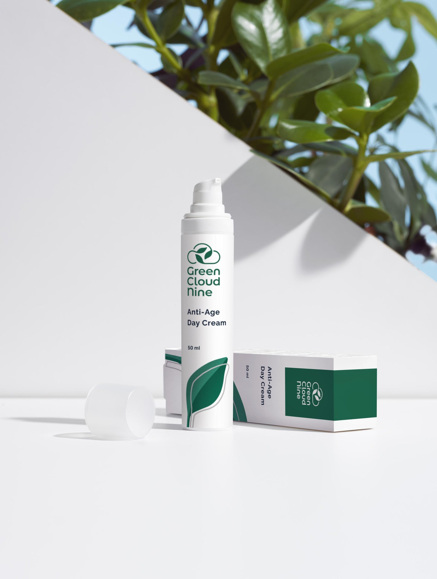 Anti-Age Day Cream with box. White pump with green cloud nine logo on a white background with plants