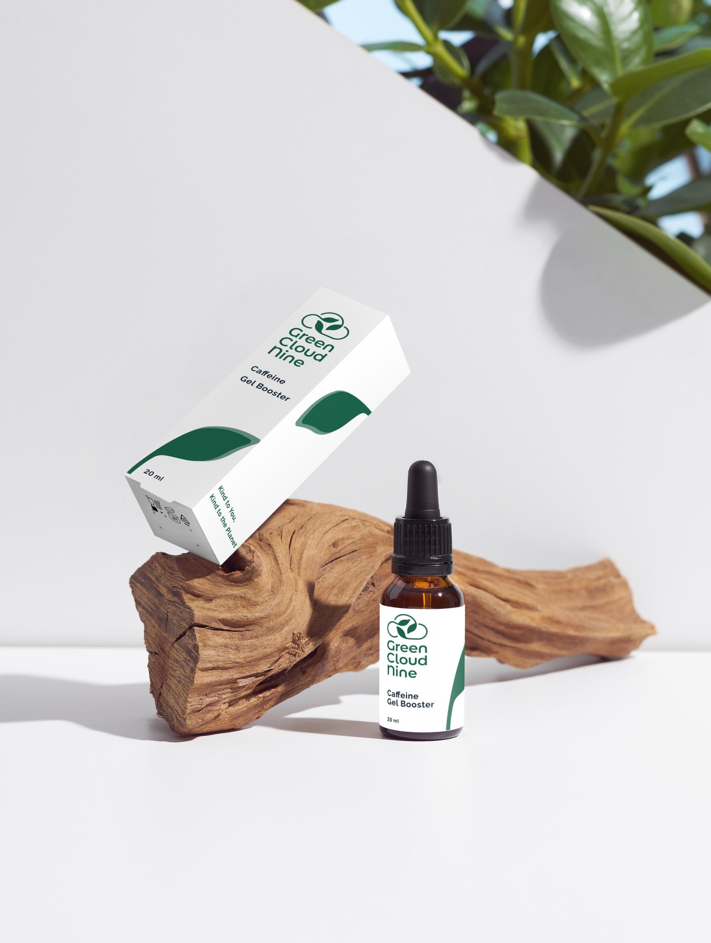 Caffeine Gel Booster glass dropper bottle with Green Cloud Nine logo on a white background with plants, displayed on wood