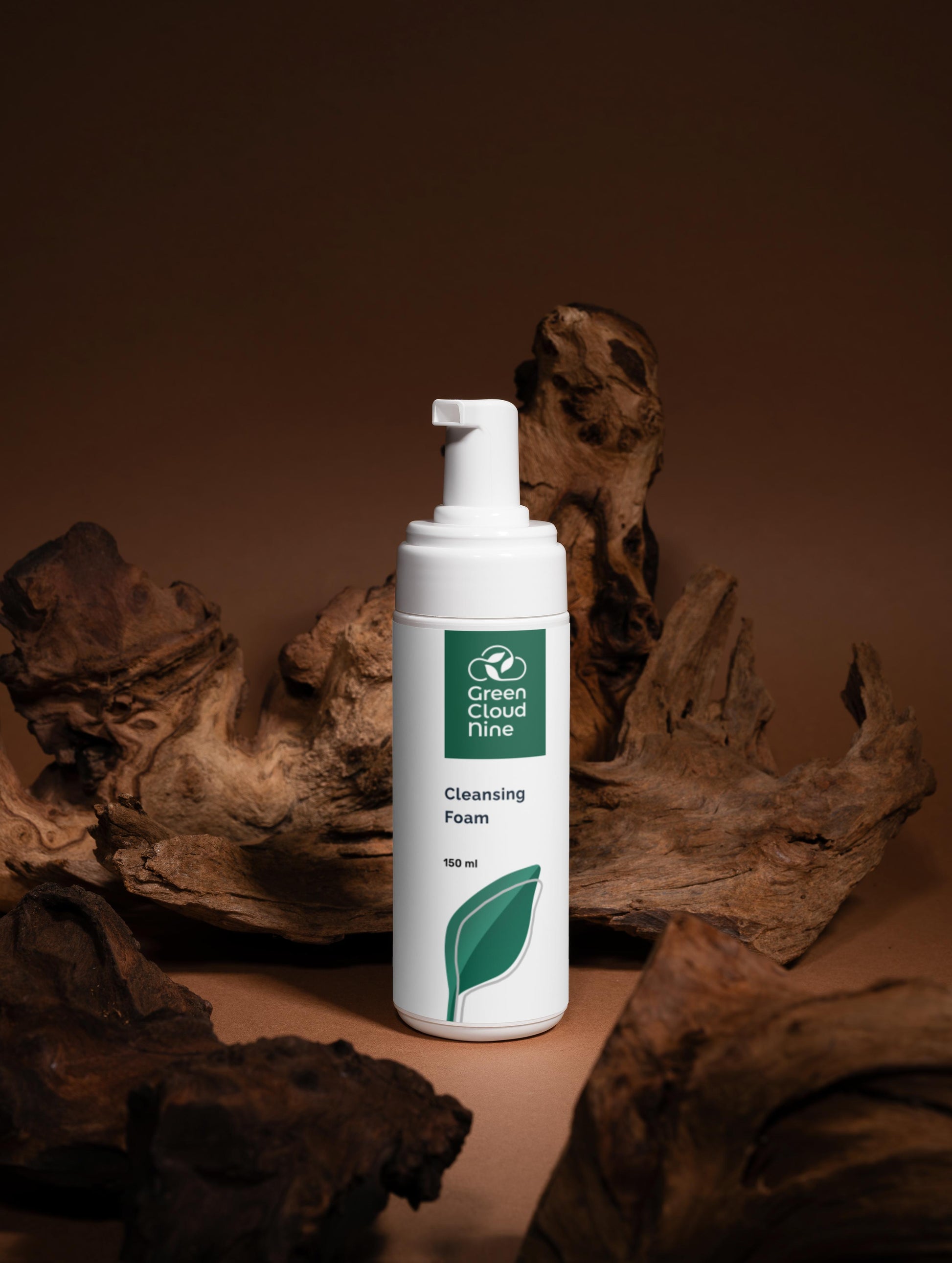White bottle of Green Cloud Farm cleansing foam with a leaf logo on a brown background