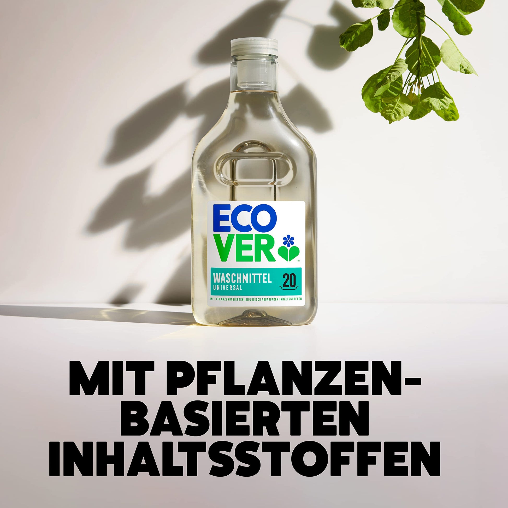 Ecover Universal Laundry Detergent in a sustainable bottle set against a white wall with green leaves