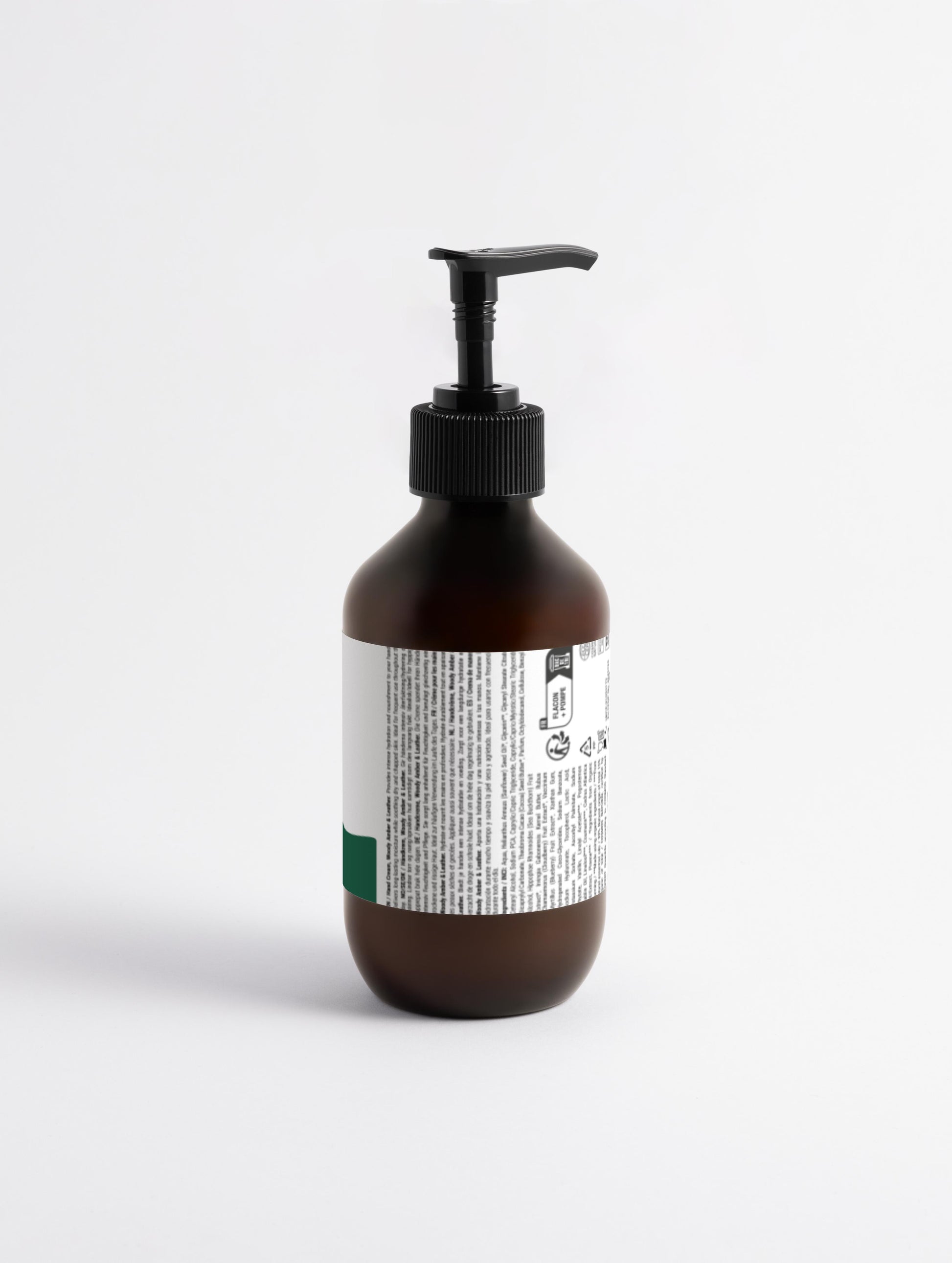 and Cream Woody Amber & Leather Back view white label on a brown pump bottle with Green Cloud Nine Logo natural ingredients vegan eco certified 