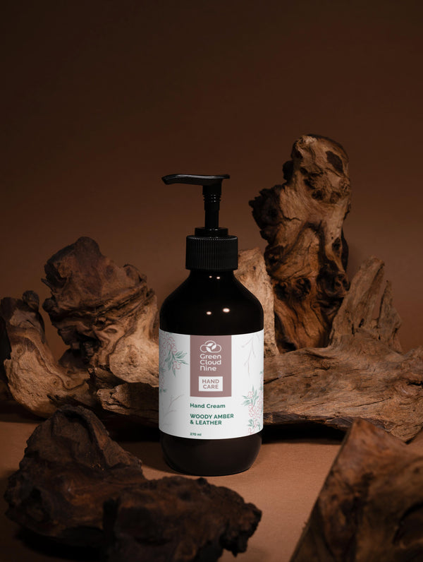 Hand cream bottle with pump dispenser on a wooden background