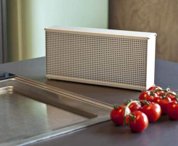 Compact LRK-2 air purifier on a kitchen counter next to a sink and fresh vine tomatoes