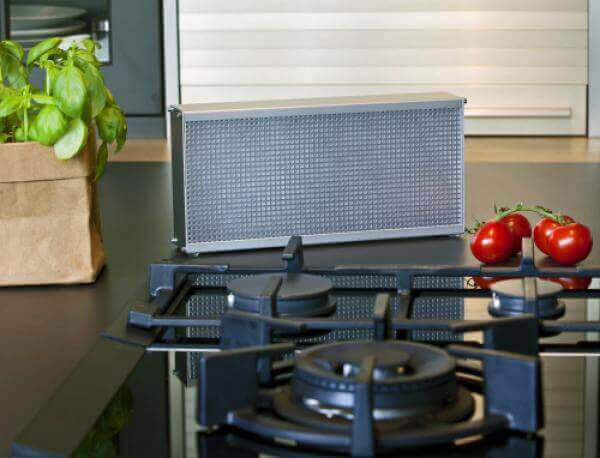 Compact LRK-2 air purifier on a kitchen counter fresh vine tomatoes and a basil plant