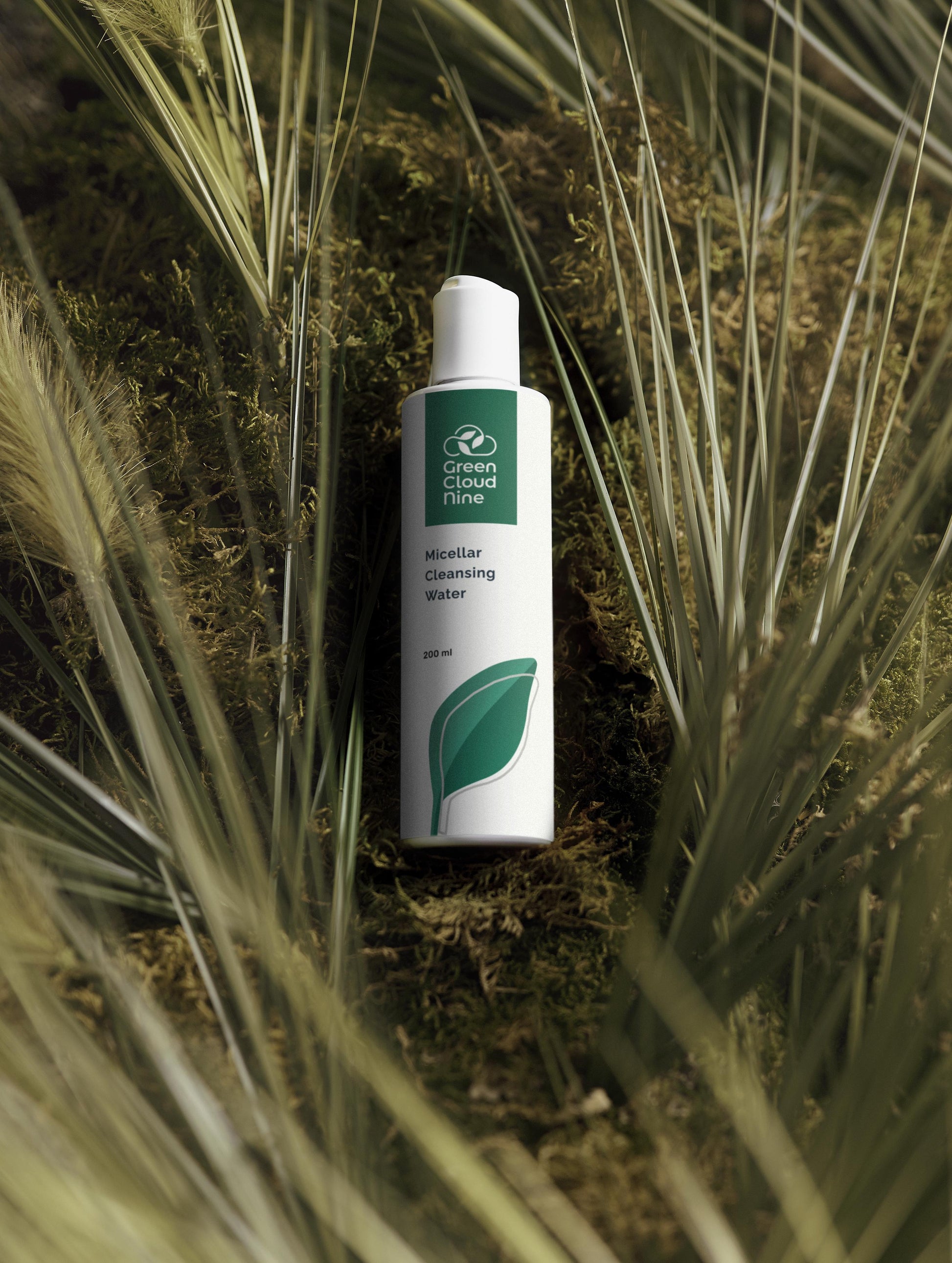  Green Cloud Nine Micellar Cleansing Water lying on a moos and grass bed