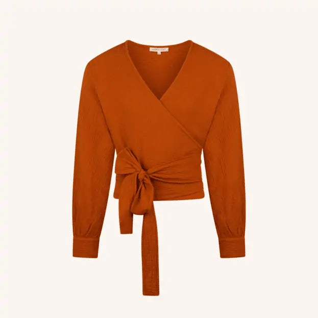 Rust-colored muslin wrap blouse with long sleeves and tie waist