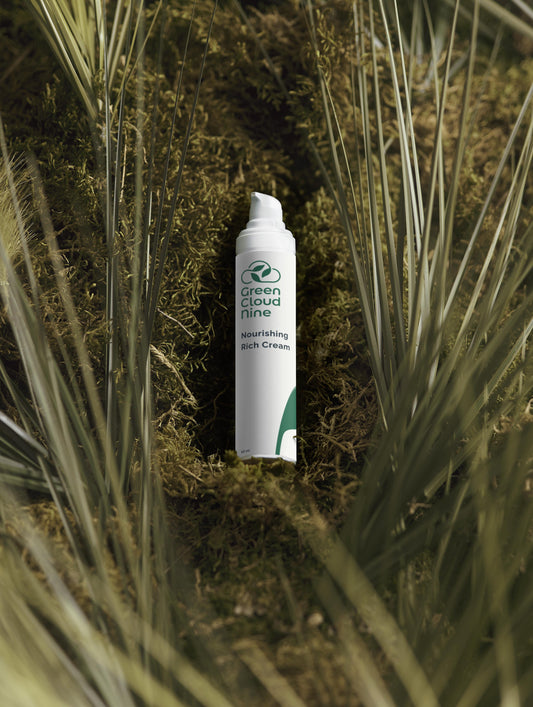 Green Cloud Nine Nourishing Rich Cream lying on a moos and grass bed