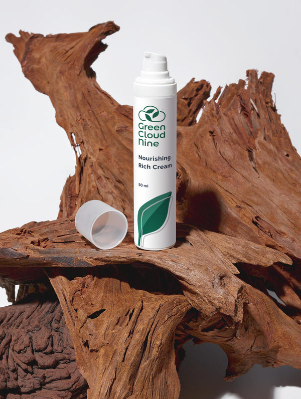 Green Cloud Nine Nourishing Rich Cream standing on drifted wood 