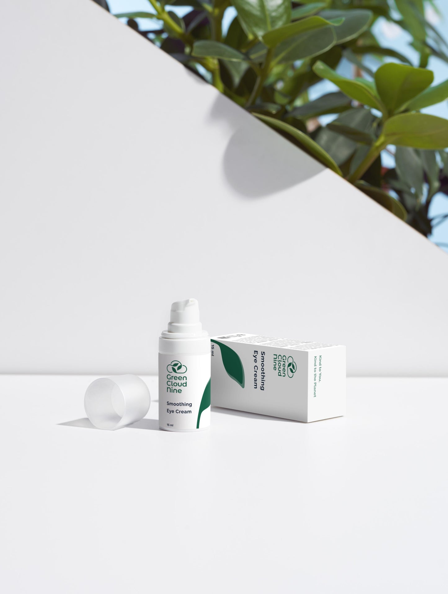 Smoothing Eye Cream with box. White pump with Green Cloud Nine logo on a white background with plants