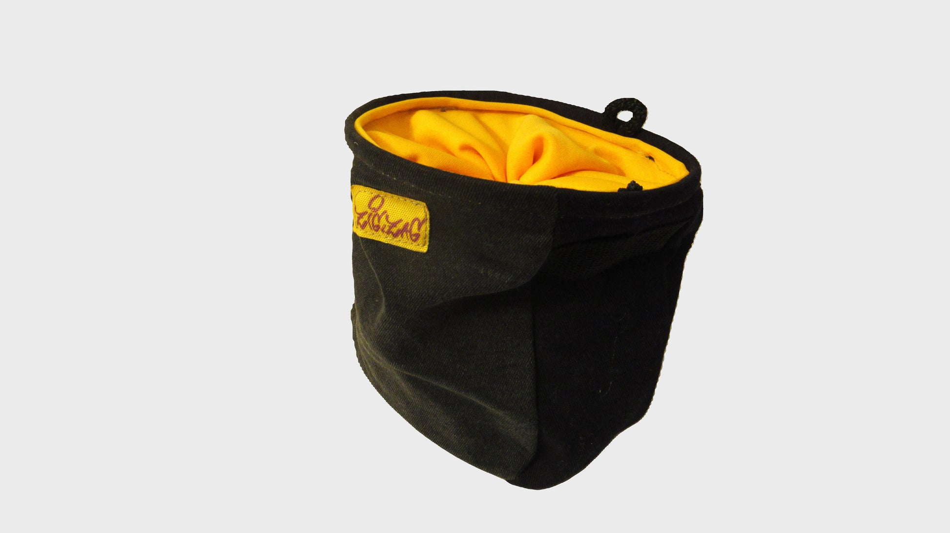 Zig Zag upcycled yellow and black chalk bag. made from repurposed textiles, combining sustainability, durability, and style for an eco-friendly fashion choice