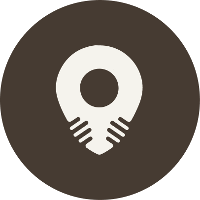 White map pin icon on a brown circle. For KIND Rituals