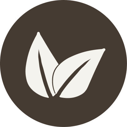 White leaf symbol on a black circular background. For KIND Rituals