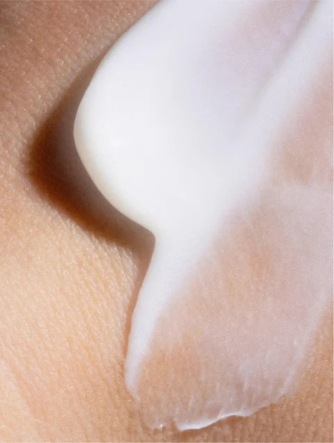 Close-up of a white cream being applied to skin. For KIND Rituals